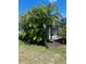 Back yard with mature landscaping around a screened lanai at 1600 Still River Dr, Venice, FL 34293