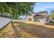 Large backyard with white fence surrounding two-story home at 1605 Acorn Seed Ct, Valrico, FL 33594