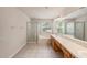 Main bathroom featuring dual sinks, walk-in shower, and a soaking tub at 1605 Acorn Seed Ct, Valrico, FL 33594