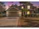 Charming home featuring a two-car garage, well-manicured lawn and mature landscaping at 1605 Acorn Seed Ct, Valrico, FL 33594
