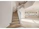 Bright foyer with staircase leading upstairs and open layout to the living area at 1605 Acorn Seed Ct, Valrico, FL 33594