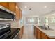 Open-concept kitchen showcasing stainless steel appliances and seamless transition to the living area at 1605 Acorn Seed Ct, Valrico, FL 33594
