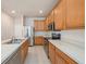 Well-lit kitchen featuring stainless steel appliances and light wood cabinetry at 1605 Acorn Seed Ct, Valrico, FL 33594