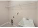 Functional laundry room with sink and overhead storage at 1605 Acorn Seed Ct, Valrico, FL 33594