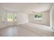 Open living room with tile and carpet flooring, ceiling fan, and ample natural light at 1605 Acorn Seed Ct, Valrico, FL 33594