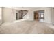Open-concept living area features a staircase, seamlessly connecting to the kitchen and dining space at 1605 Acorn Seed Ct, Valrico, FL 33594