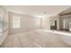 Expansive living room with neutral carpet, ample natural light, and modern lighting fixture at 1605 Acorn Seed Ct, Valrico, FL 33594