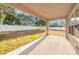 Covered patio with large fenced backyard and manicured lawn at 1605 Acorn Seed Ct, Valrico, FL 33594