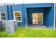 Covered back patio area with sliding glass door, and a view of the lush lawn at 1933 Oxnard Ct, Tampa, FL 33612