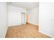 Bright, empty bedroom with luxury vinyl flooring, double closets, and an ensuite bathroom entrance at 1933 Oxnard Ct, Tampa, FL 33612