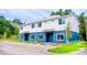 Modern townhome featuring blue and white exterior paint, and ample parking at 1933 Oxnard Ct, Tampa, FL 33612