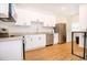 Modern kitchen features white cabinets, stainless appliances, granite counters and modern decor at 1933 Oxnard Ct, Tampa, FL 33612