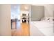 Bright kitchen with stainless appliances and white cabinetry, flows to the living area, and features a laundry center at 1933 Oxnard Ct, Tampa, FL 33612