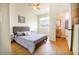 Bedroom with ensuite bathroom features ceiling fan, picture window, and modern decor at 1933 Oxnard Ct, Tampa, FL 33612