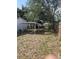 Large backyard with a covered parking area and privacy fence at 1935 W Union St, Tampa, FL 33607