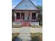 Charming home with a covered porch and red accents at 1935 W Union St, Tampa, FL 33607