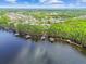 Aerial view of a lakeside community with docks, lush greenery, and blue water at 21215 Preservation Dr, Land O Lakes, FL 34639