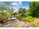 Exterior view of a back deck and table that overlook the fenced yard and greenery at 21215 W Preservation N Dr, Land O Lakes, FL 34639