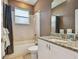 Cozy bathroom with tile floors, shower and tub combination, granite countertop, and decorative mirror at 21215 Preservation Dr, Land O Lakes, FL 34639
