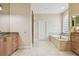 An elegant bathroom boasts tile floors, a large mirror, double granite countertop, and a luxurious soaking tub at 21215 Preservation Dr, Land O Lakes, FL 34639
