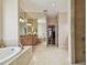Bright and spacious bathroom featuring double sinks, a jacuzzi tub, and a separate walk-in shower at 21215 Preservation Dr, Land O Lakes, FL 34639