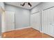 Bedroom with hardwood floors, neutral walls, two closets, and a window with coverings at 21215 Preservation Dr, Land O Lakes, FL 34639