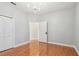 Bedroom with hardwood floors, a chandelier, neutral walls, and a closet with folding doors at 21215 Preservation Dr, Land O Lakes, FL 34639