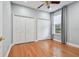 Bedroom with hardwood floors, neutral walls, two closets, and a window with coverings at 21215 Preservation Dr, Land O Lakes, FL 34639