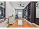 Cozy room featuring hardwood floors, built-in shelves, modern ceiling fan, and natural light through the window at 21215 Preservation Dr, Land O Lakes, FL 34639