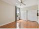 A spare bedroom with hardwood floors, a ceiling fan, and two large closets offering ample storage space at 21215 Preservation Dr, Land O Lakes, FL 34639