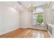Sunlit dining room with hardwood floors, large window, and elegant chandelier at 21215 Preservation Dr, Land O Lakes, FL 34639