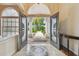 Grand entryway with double doors, tiled floors, and views of the well-manicured front yard at 21215 Preservation Dr, Land O Lakes, FL 34639