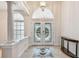 Spacious foyer with decorative tiled floor, double doors, and architectural details at 21215 Preservation Dr, Land O Lakes, FL 34639