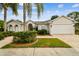 Charming single-story home with manicured lawn and brick-paved driveway at 21215 Preservation Dr, Land O Lakes, FL 34639