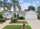 Beautiful one-story home with a well-manicured lawn, brick driveway and mature palm trees at 21215 Preservation Dr, Land O Lakes, FL 34639