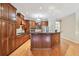 Spacious kitchen features wooden cabinetry, stainless steel appliances, and an island with dark countertop at 21215 Preservation Dr, Land O Lakes, FL 34639