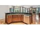 Open kitchen with stainless dishwasher, sink, granite countertops, and views to outdoor living area with fireplace at 21215 Preservation Dr, Land O Lakes, FL 34639