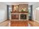 Cozy stone fireplace with wooden mantel, cabinets, and shelving creates a focal point in the living space at 21215 Preservation Dr, Land O Lakes, FL 34639