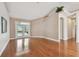 Bright and airy living room featuring hardwood floors and French doors leading to the pool area at 21215 Preservation Dr, Land O Lakes, FL 34639