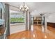 Open living room with fireplace, hardwood floors, and screened-in outdoor pool view at 21215 Preservation Dr, Land O Lakes, FL 34639