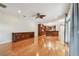 Expansive living area with wood floors, custom built ins, and kitchen with island in background at 21215 Preservation Dr, Land O Lakes, FL 34639
