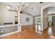 Open-concept living room featuring hardwood floors, high ceilings, and views of the pool area at 21215 Preservation Dr, Land O Lakes, FL 34639