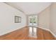 Bright and airy living room featuring hardwood floors and French doors leading to the pool area at 21215 Preservation Dr, Land O Lakes, FL 34639
