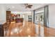 Open floor plan featuring hardwood floors, wood built ins, and access to kitchen and outdoor living space at 21215 Preservation Dr, Land O Lakes, FL 34639