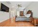 Large main bedroom features wood floors, ceiling fan, and ample space for bedroom furniture at 21215 Preservation Dr, Land O Lakes, FL 34639