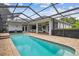 Screened-in pool with brick patio and view of the rear exterior of the home at 21215 Preservation Dr, Land O Lakes, FL 34639
