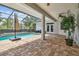 The screened pool with brick patio and ceiling fan features a lovely outdoor living area at 21215 Preservation Dr, Land O Lakes, FL 34639