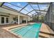 Enclosed backyard pool with brick paver patio and outdoor ceiling fans at 21215 Preservation Dr, Land O Lakes, FL 34639