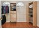 Walk-in closet with storage shelving, hanging racks and hardwood flooring at 21215 Preservation Dr, Land O Lakes, FL 34639