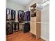 Walk-in closet with storage shelving, hanging racks and hardwood flooring at 21215 Preservation Dr, Land O Lakes, FL 34639